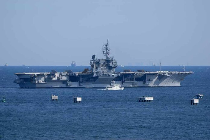 Aircraft carrier at sea with small boat alongside