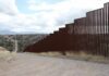Border fence along a hilly landscape
