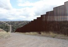 Border Games Escalate: Finland Draws Line Border fence along a hilly landscape
