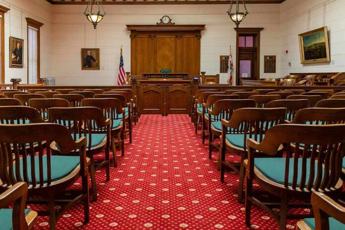 Courtroom with wooden benches facing the judge's bench