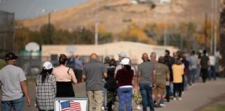 voters standing in a long line outside a polling place