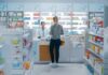 Yvonne Li assisting a customer at a pharmacy counter