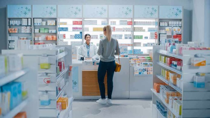 Yvonne Li assisting a customer at a pharmacy counter