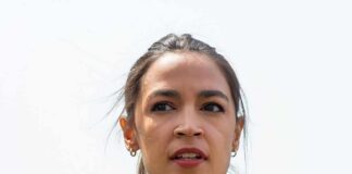 woman speaking outdoors with neutral background