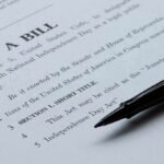 Fee Overcharge Bombshell Hits Obamacare Bill document with black pen on paper