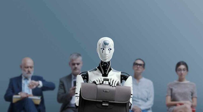 Jan-Peter Nikiferow seated with a humanoid robot holding a briefcase in front