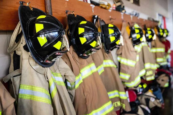 Firefighter helmets and turnout coats hanging on hooks
