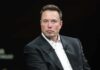 Elon Musk in a dark suit during an onstage talk