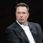 Elon Musk in a dark suit during an onstage talk
