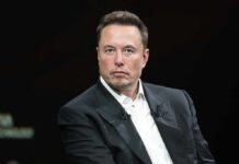 Elon Musk in a dark suit during an onstage talk
