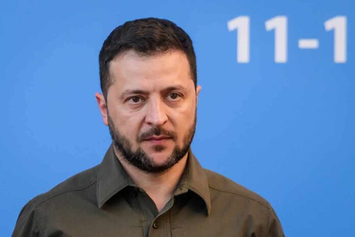 man in olive shirt against blue background