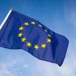 European Union flag waving against blue sky