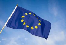 European Union flag waving against blue sky