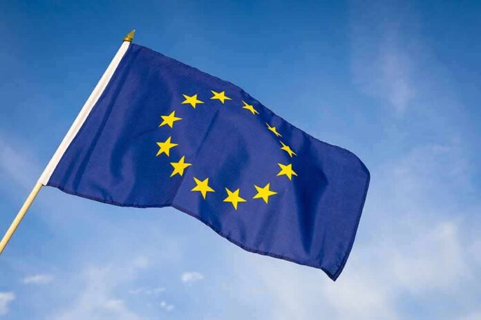 European Union flag waving against blue sky