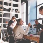 Coworkers collaborating at a desk in a modern office