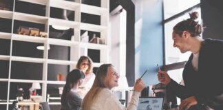 Coworkers collaborating at a desk in a modern office