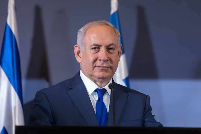 man in suit at podium with microphones