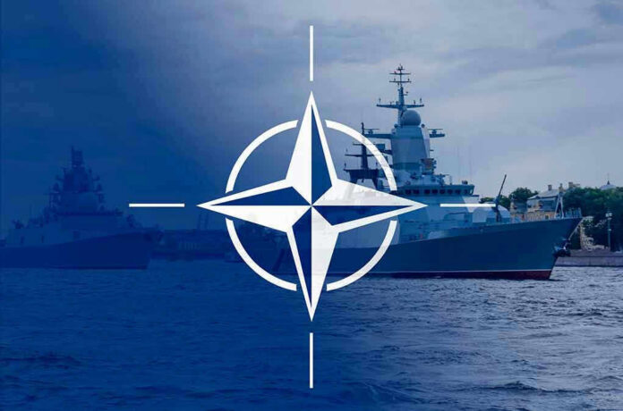NATO emblem overlaying naval ships in the ocean.