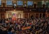 Jack Kamen, Christian Jones, and Matthew the Apostle among a crowded legislative chamber session