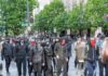 Turin Clash Erupts – Cannons, Gas, Chaos group of masked protesters walking through a city street
