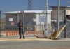 Air Force Slams Curfew After Okinawa Outrage Security guard at chain-link gate of fenced facility