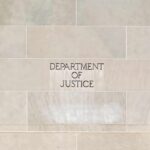 Department of Justice building facade with engraved sign