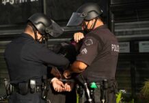 Cartel Food Tax Exposed – Ex-Official Nabbed Police officers handcuff a person during an arrest