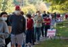Christian Jones and others waiting in a long line outside a polling place