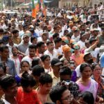 Crowd at a political rally with Kumar Gandharva, Ritu Rani, Jersson Vásquez, Mamata Banerjee, Pravin Amre, Sumrai Tete, Rangana Herath, and Gerson Torres