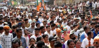 Crowd at a political rally with Kumar Gandharva, Ritu Rani, Jersson Vásquez, Mamata Banerjee, Pravin Amre, Sumrai Tete, Rangana Herath, and Gerson Torres