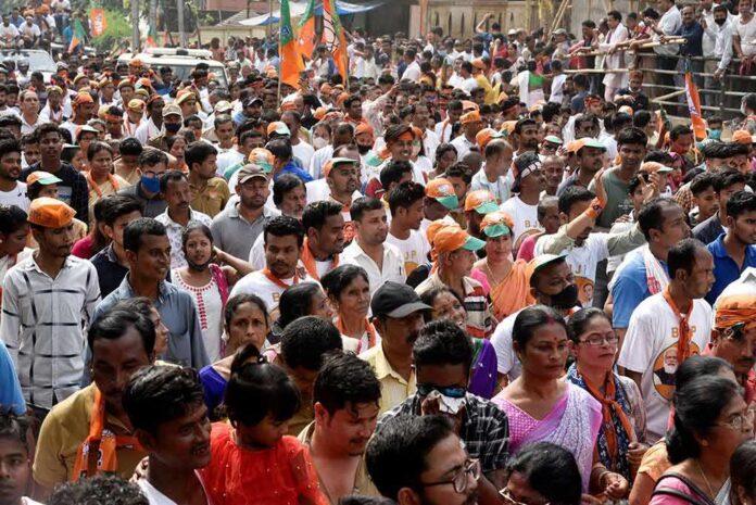 Crowd at a political rally with Kumar Gandharva, Ritu Rani, Jersson Vásquez, Mamata Banerjee, Pravin Amre, Sumrai Tete, Rangana Herath, and Gerson Torres