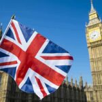 Evacuation Talk Rocks UK Island Union Jack flag with Elizabeth Tower in the background