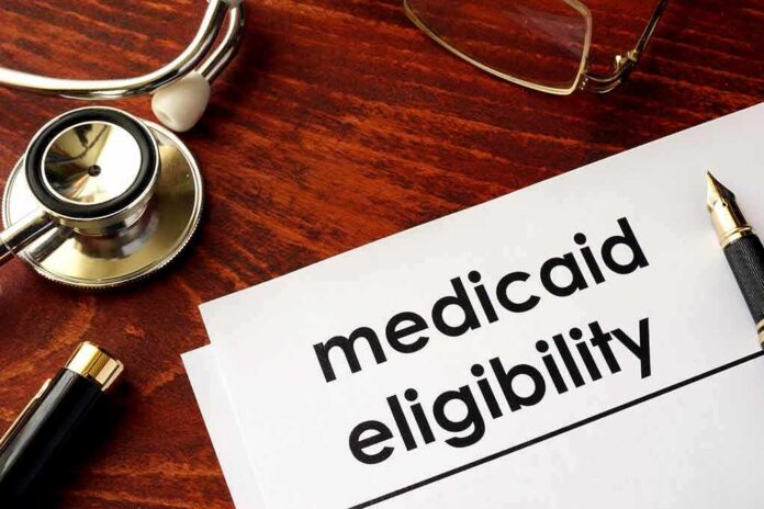Medicaid eligibility form with stethoscope and pen on desk